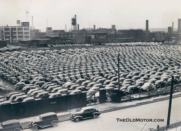 The pattern of this field full of what appear to be 1939 Desoto or Plymouth
